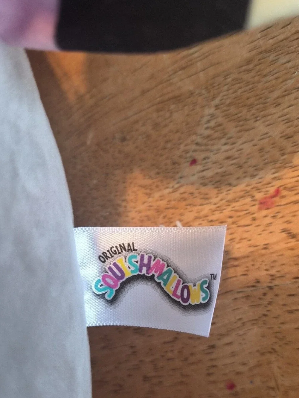 Squishmallows Plush Tag with Rainbow Lettering on White